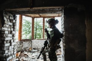 Soldier talking on the walkie-talkie inside the building, military concept